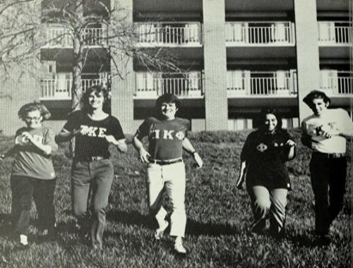 Students pose outside residence